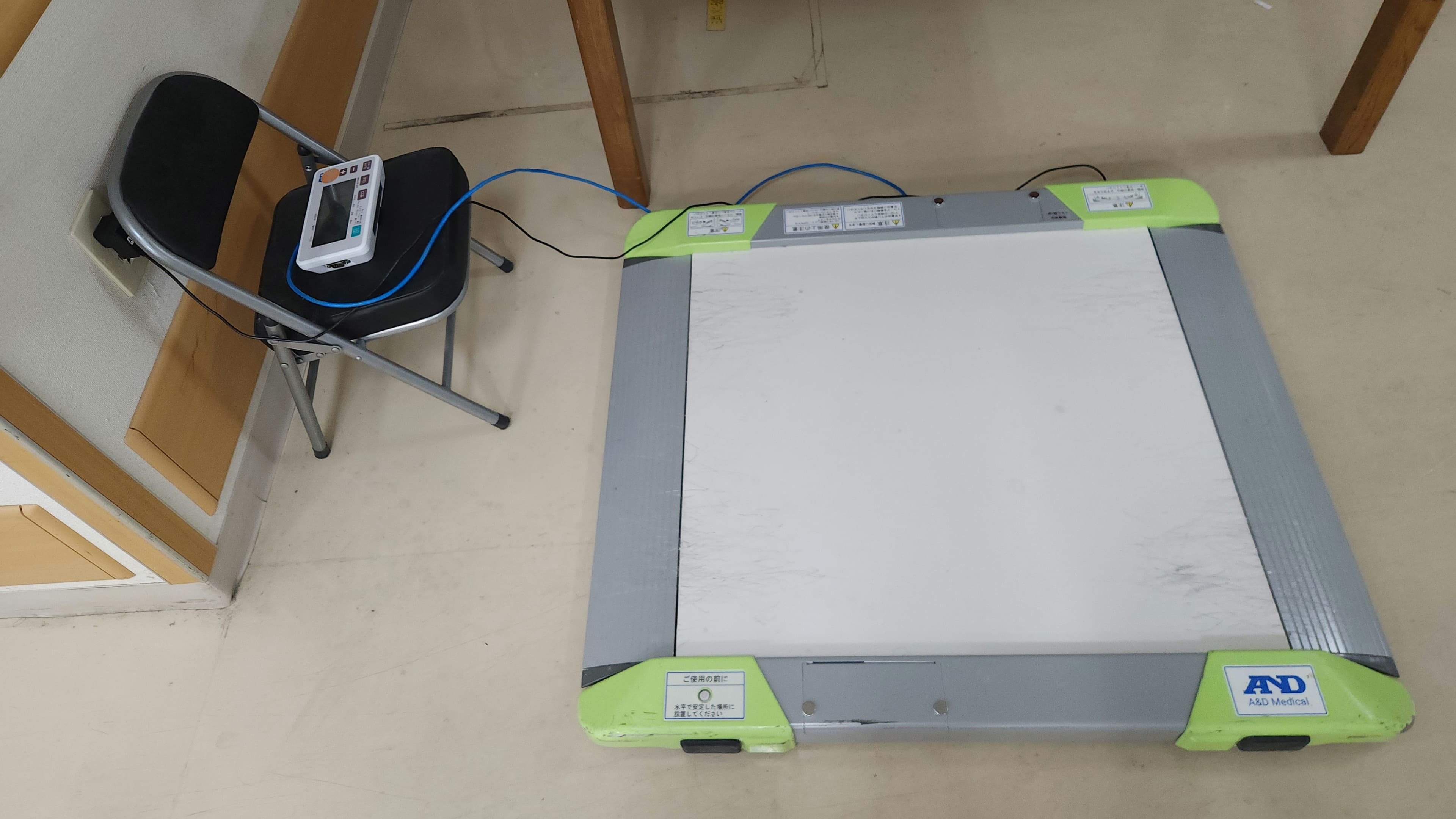 A low platform scale designed for weighing a wheelchair user in a clinical setting