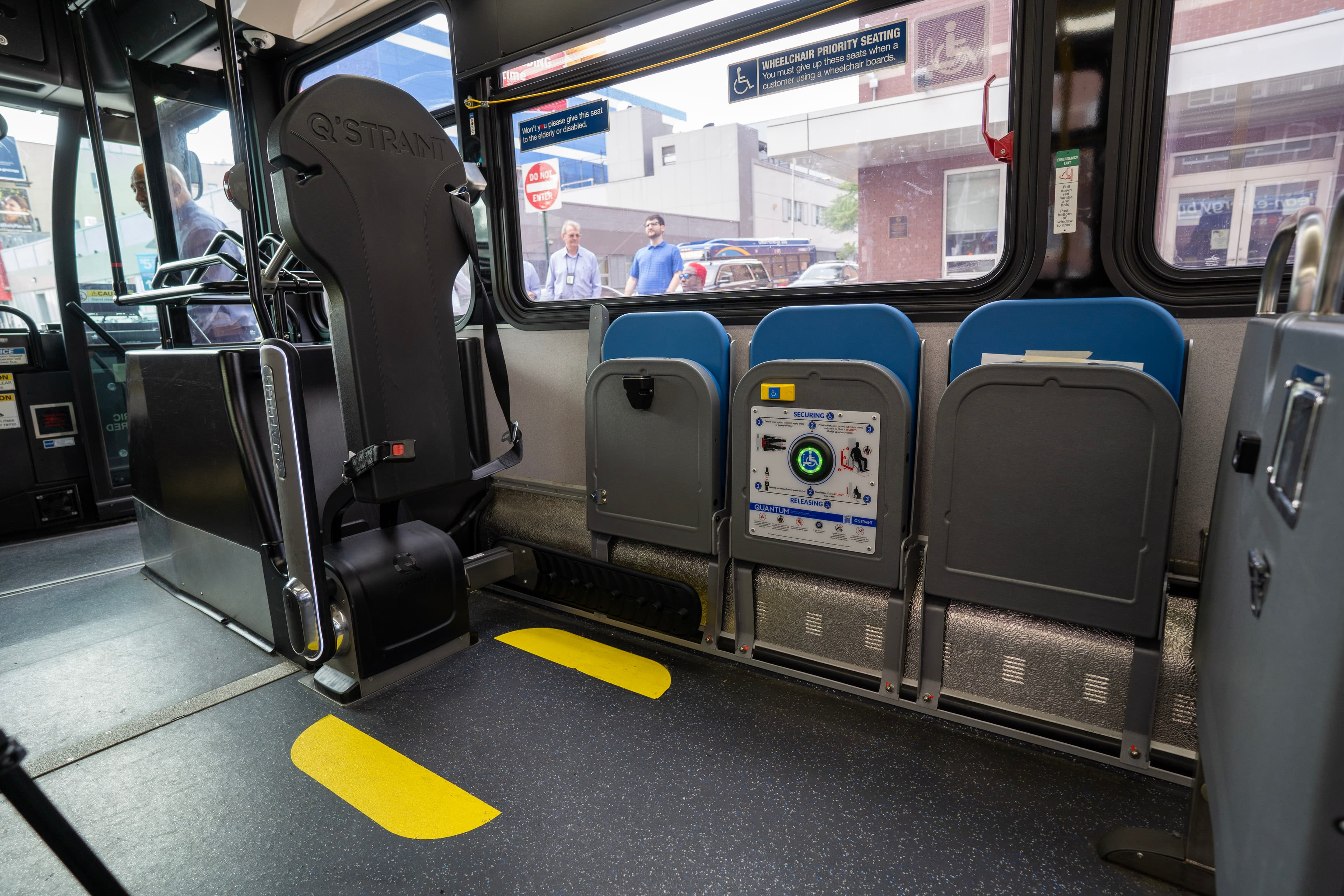 Approved wheelchair tie-down straps attached to marked anchor points inside an accessible vehicle